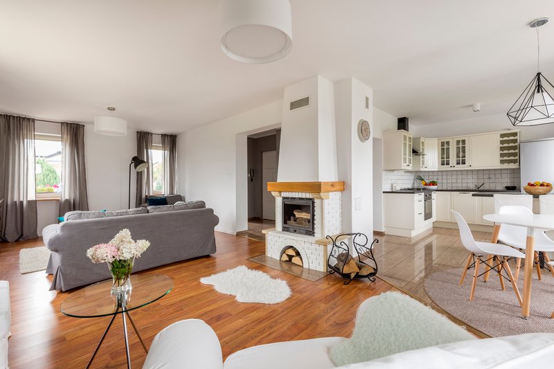 Cocina moderna de lujo en Puebla con isla central blanca, encimeras de cuarzo y lámparas colgantes esféricas de diseño contemporáneo.